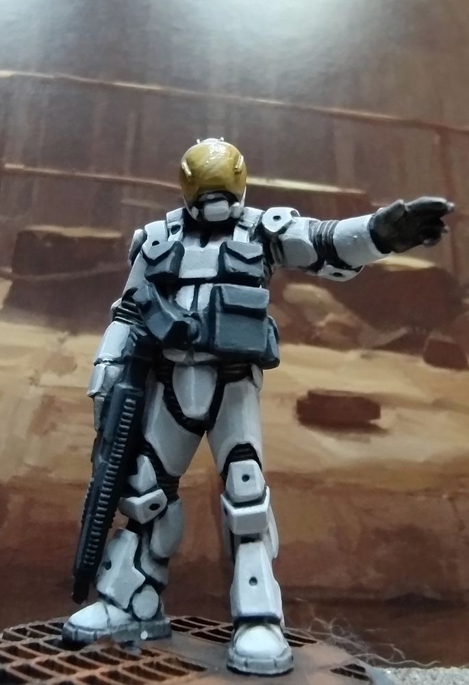 28mm Science fiction figure in grey-white armour pointing to the right