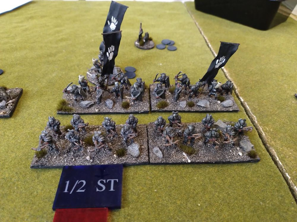 15mm Uruk-hai miniatures with black banners with a painted white hand on them