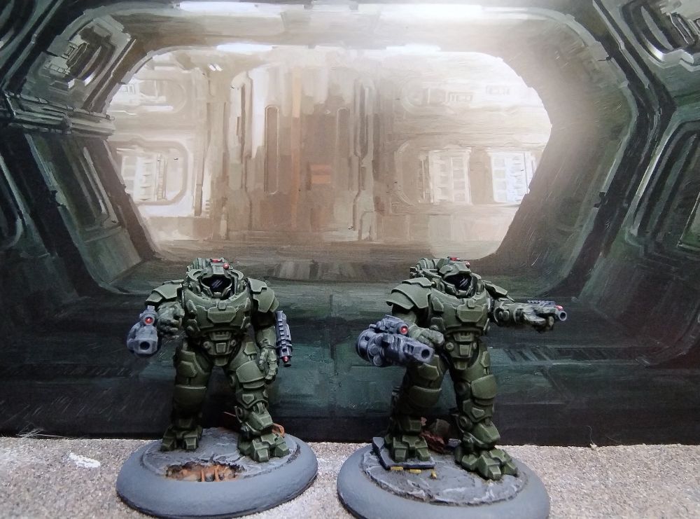 Two 28mm Science fiction figures in heavy armour armed with heavy grenade launchers. 