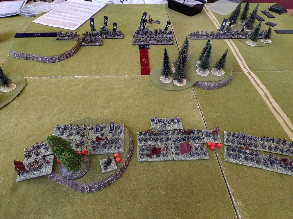 15mm fantasy wargame with an army dwarves facing Uruk-hai in the distance

