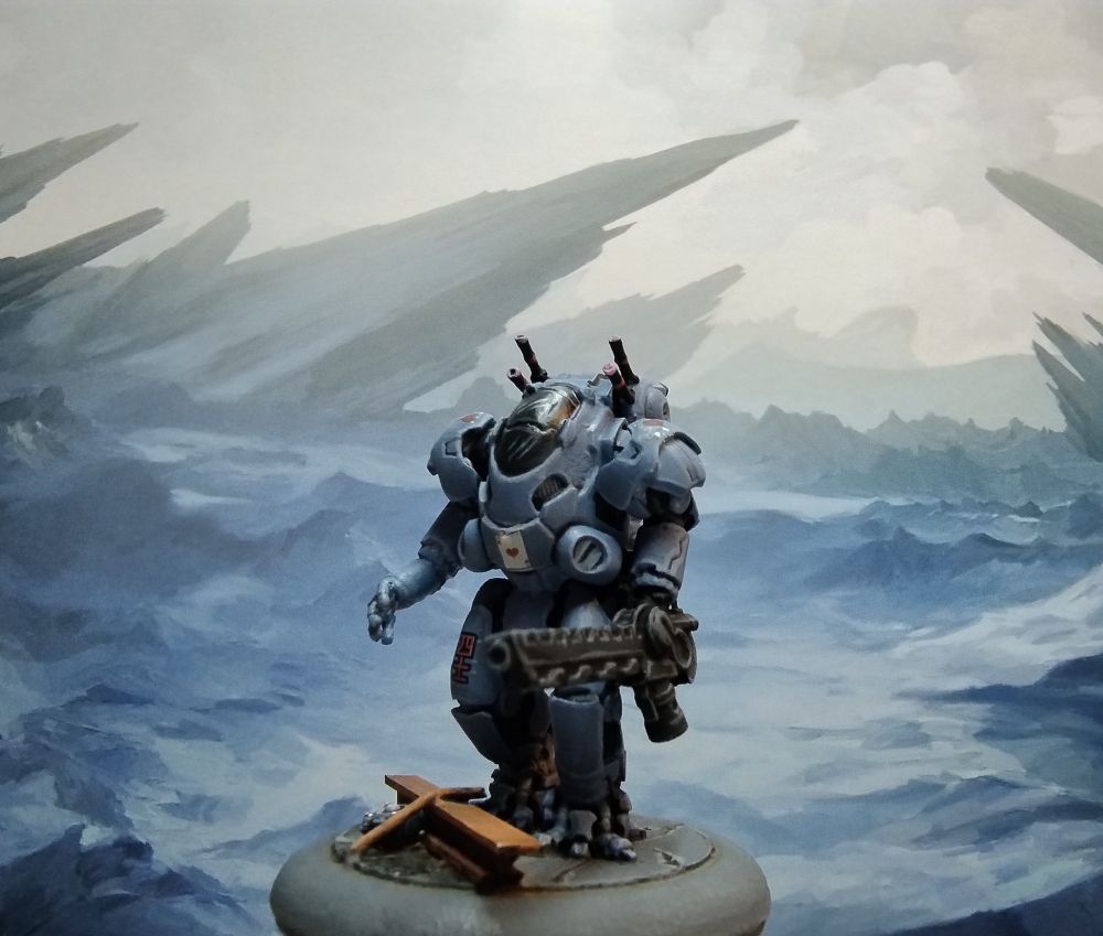 Blue gray science fiction miniature matching the stark blue gray landscape in the background 