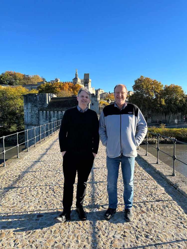 Austin & JC Lambert, vigneron at domainedespasquiers.fr, on the Pont Saint-Benezet (Le Pont d'Avignon) with le Palais des Papes in the background