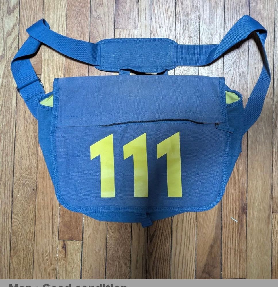 bright blue Vault 111 messenger bag, with pastel yellow lettering/ interior  :(