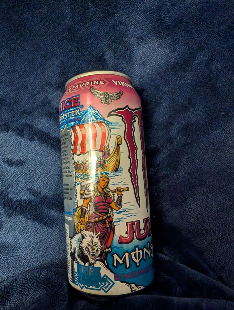 Monster can, viking berry, it's a sunset over a fjord with a longboat and a sexy viking lady with an axe next to a wolf.