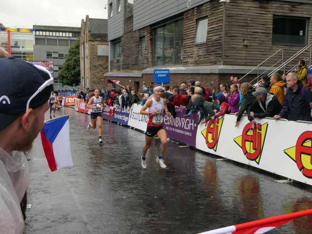 Run in at the 2024 knockout sprint race (quarter final). Czechia flag on the left, wet road and spectators below university buildings