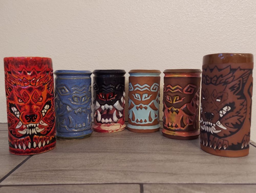 6 colorful mugs with animal faces, all are toothy.