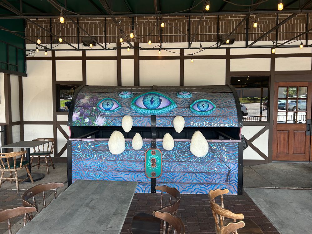 Picture of huge mimic chest on patio of Emerald Tavern & Games in Austin, TX. Boardgame cafe that offers cocktails/beer/mead/food. 