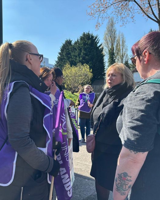 Christina talking to healthcare support workers on the picket line.