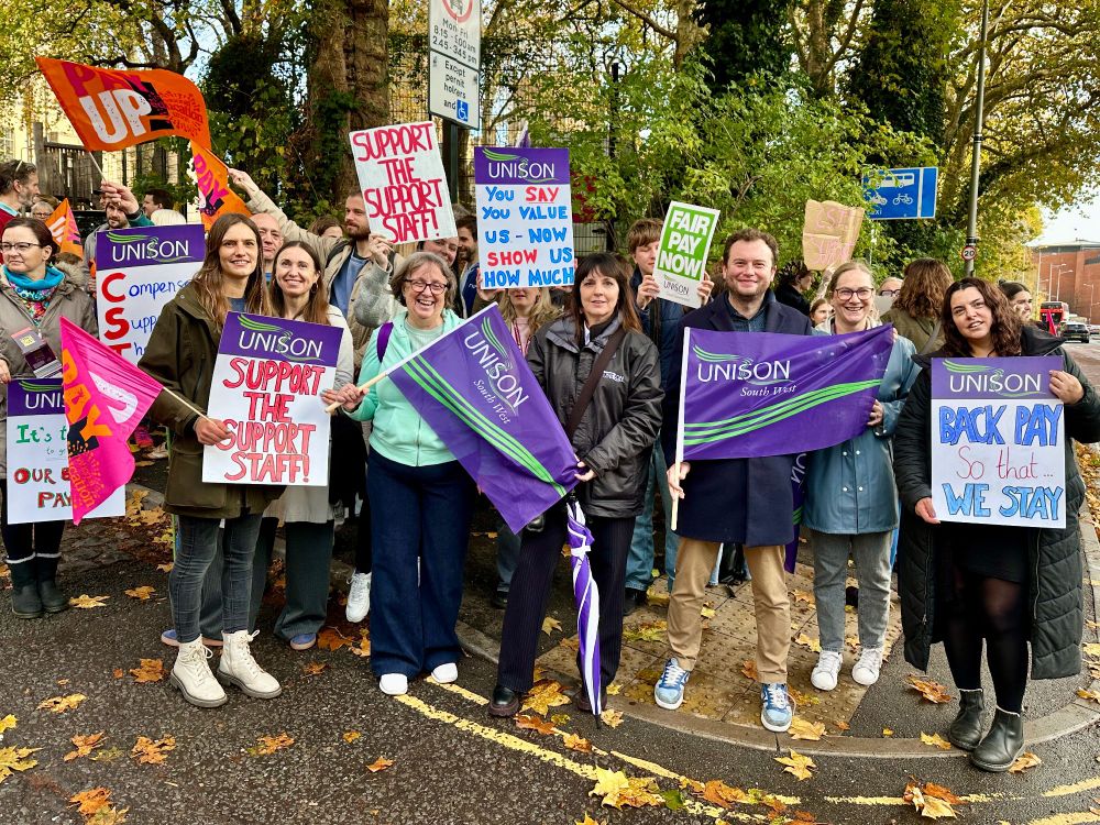 School staff from Cathedral Schools Trust protesting with banners in dispute over back pay.