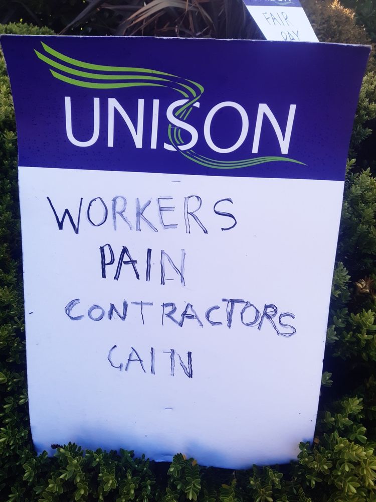 Placard: workers pain, contractors gain