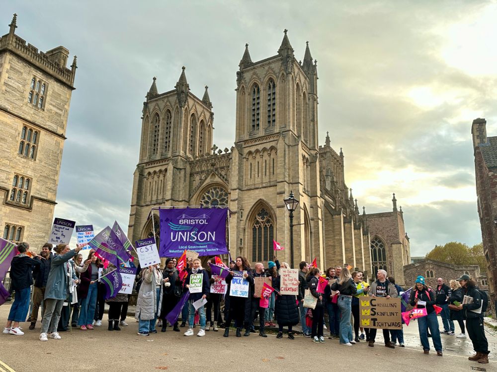 School staff from Cathedral Schools Trust protesting with banners in dispute over back pay.