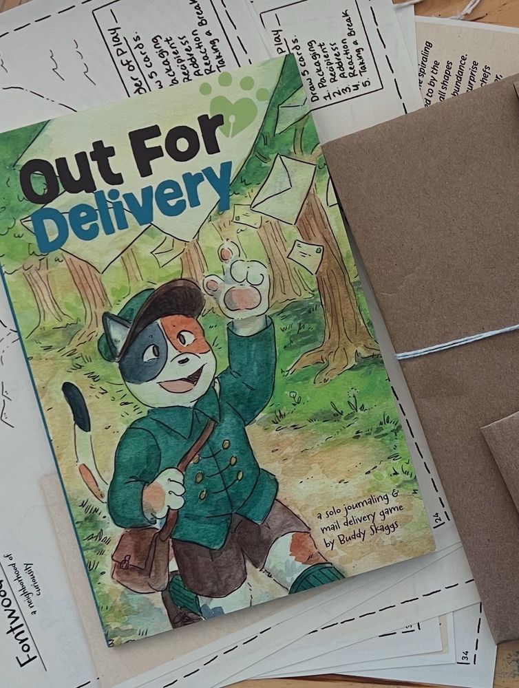 A booklet with a cat on the cover called "Out For Delivery. It sits on top of a pile of maps and packages
