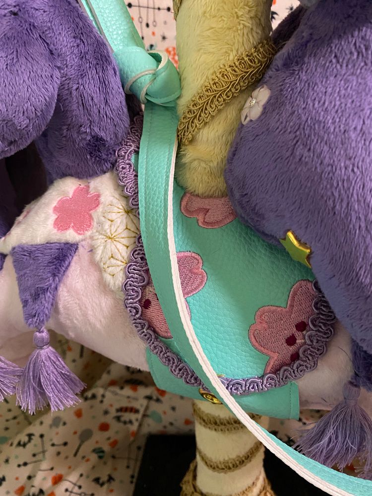 Close up on the saddle and blanket of the carousel horse plush