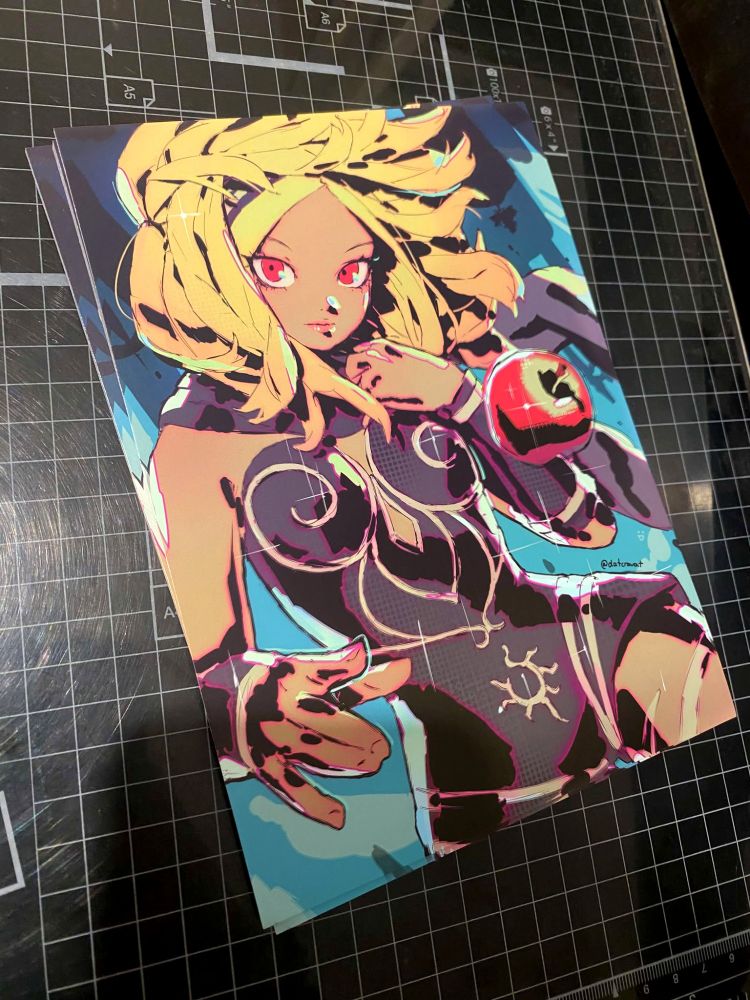 A photo of a pile of prints of the above art of Kat.