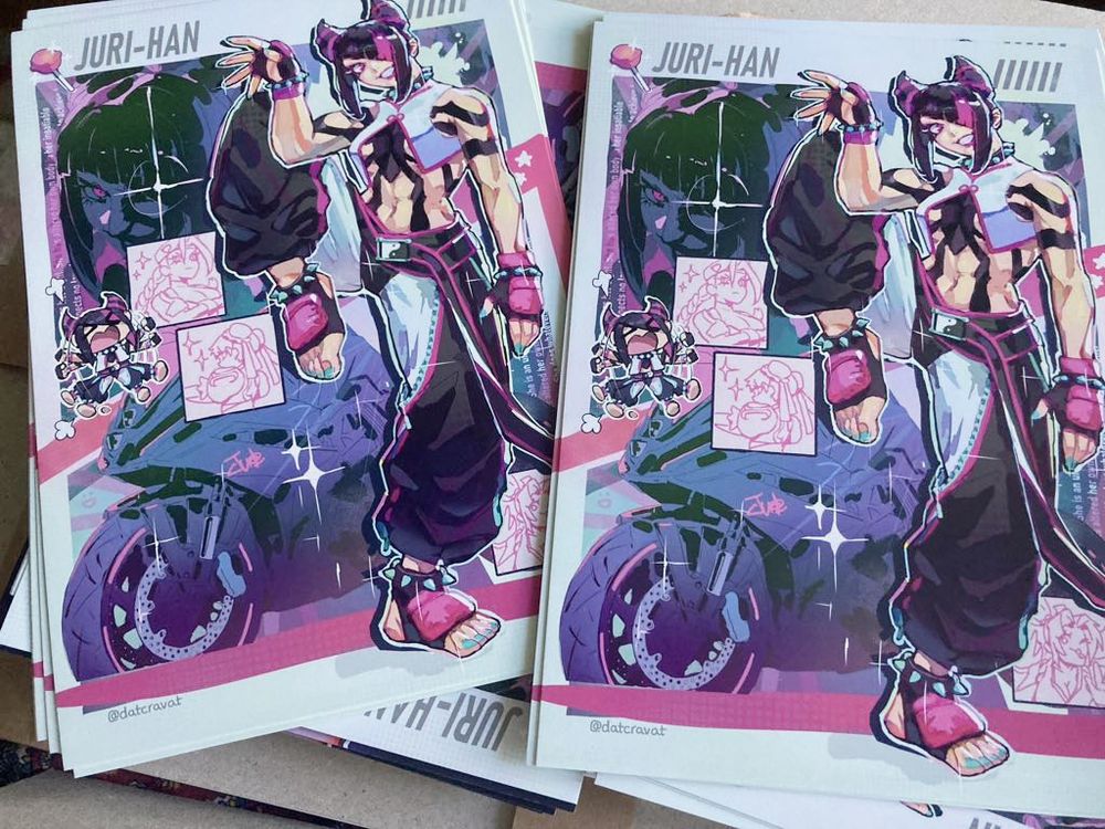 Two piles of art prints of the above artwork of Juri Han.