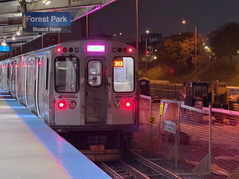 pink line L train at a station (Racine) on the blue line
