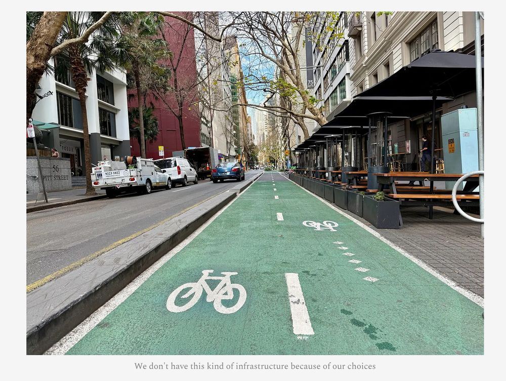 Photo of a street with, from left to right:
- street parking
- open road
- protective barrier
- green, two-way bike lanes
- wide sidewalk with tables for eating

Caption: We don't have this kind of infrastructure because of our choices