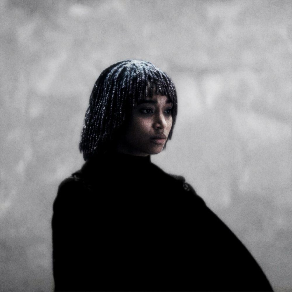 Sith Osha edit by Amp where the character Osha is dressed entirely in black in front of a light but hazy background 
