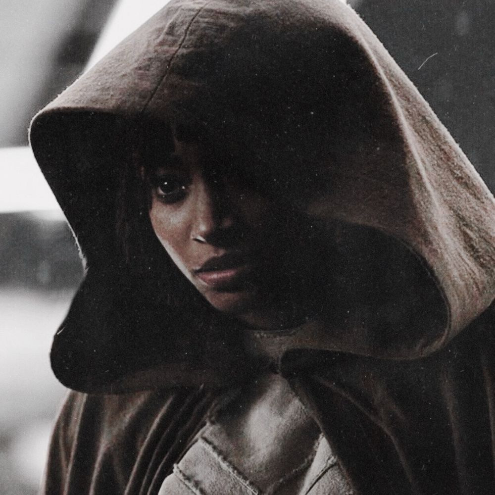 Osha with her hood cloak up and it partially hides one eye. This edit is by Amp.