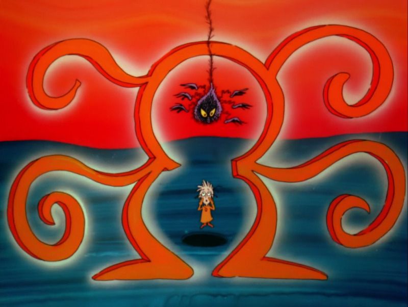 A small boy is underneath a large scary looking spider.