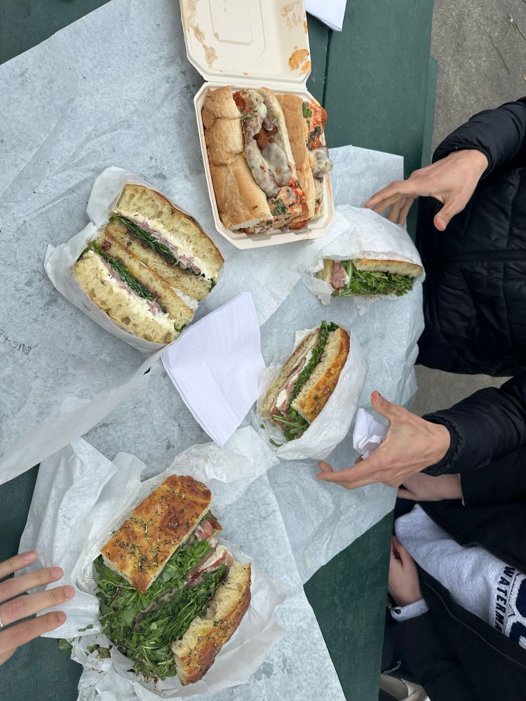 A chicken parm sandwich, a Brie arugula 
prosciutto fig sandwich and two arugula chicken cutlet sandwiches 