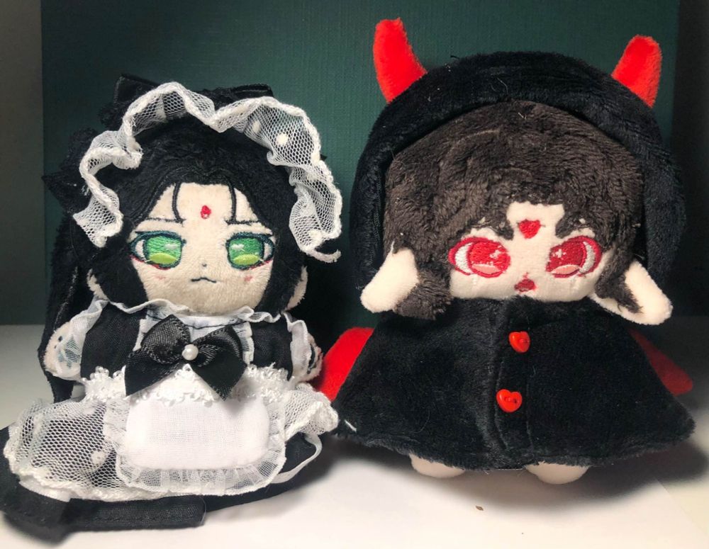 left side is a 10cm shen qingqiu cotton doll in a maid outfit, right side is a 10cm luo binghe doll in a devil costume