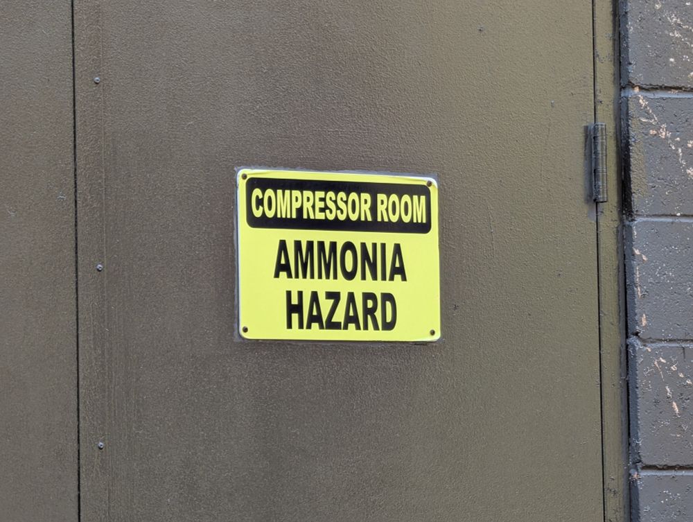 A sign saying:
Compressor Room
Ammonia Hazard