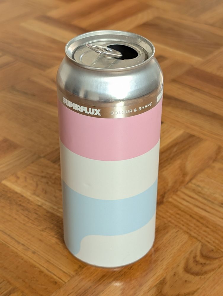 A can of Superflux brewery's Colour & Light
The can features three prominent horizontal stripes:
pink, white, and light blue