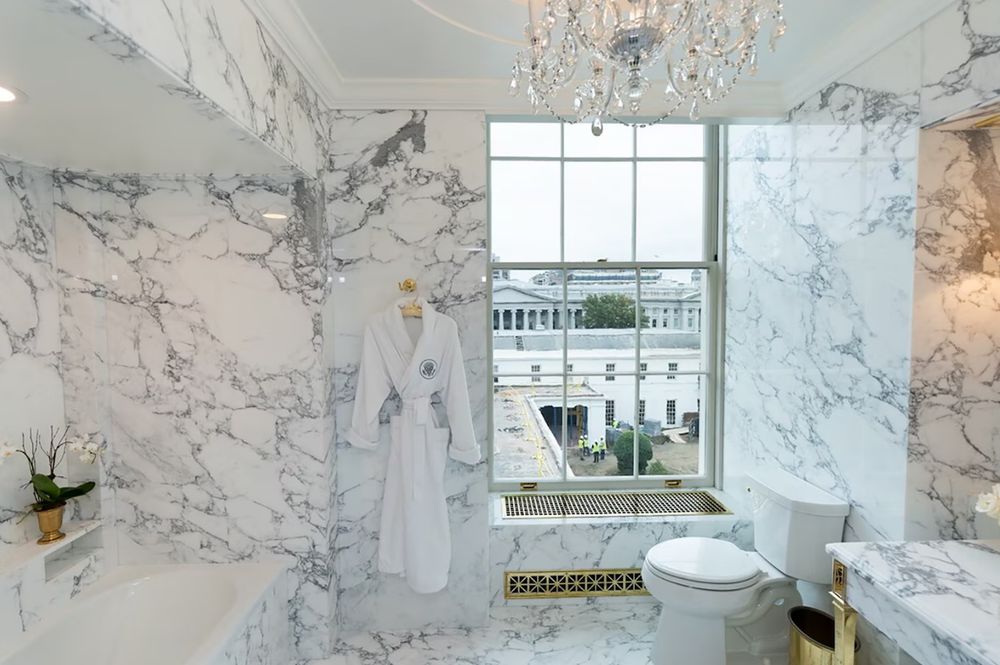tRump's redecorated Lincoln bathroom in white and black-veined marble. Also, chandelier for lighting.