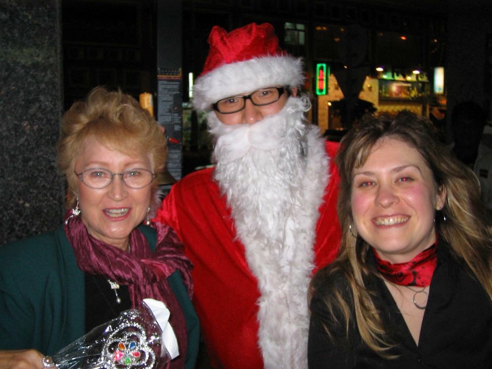 Two women with a Filipino Santa in the middle. 