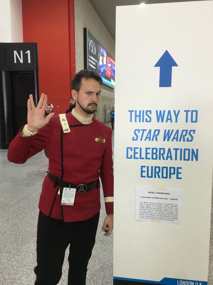 A Photo of me in a Star Trek Uniform standing infront of a sign saying 'This Way to Star Wars Celebration Europe'