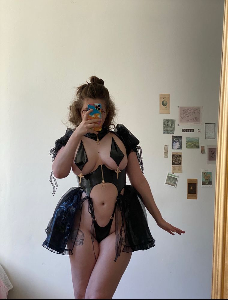 cosplayer with tattoos taking a mirror selfie in lingerie