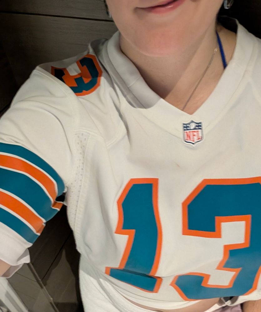 Eva in a #14 Dolphins jersey
