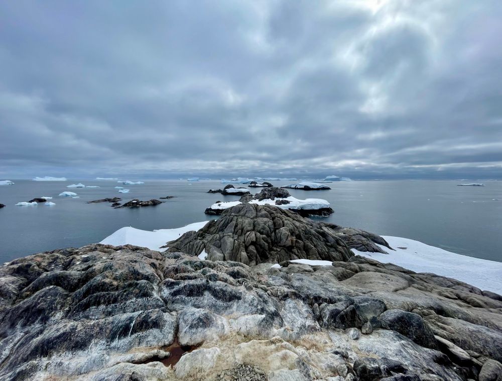 Rocky islands with icebergs and clouds 