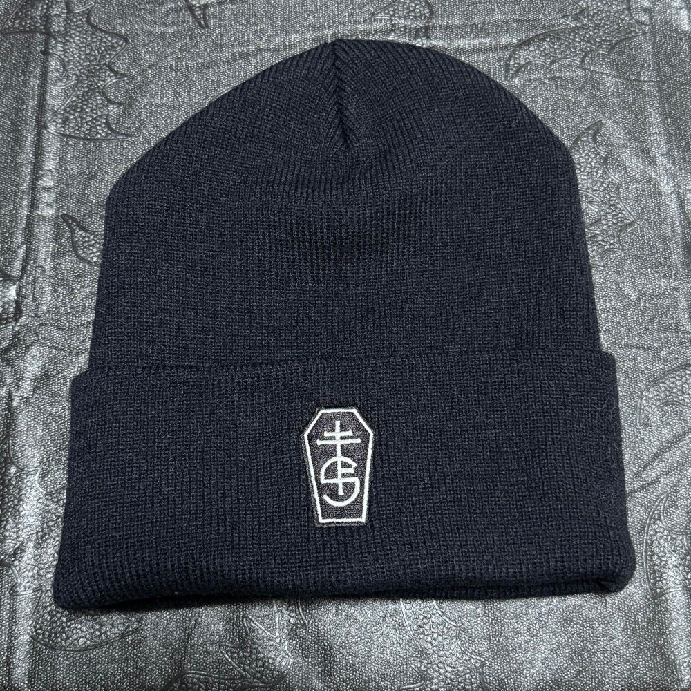 Black beanie with a white firebrand, logo of the Free Society Satanists, encased in a coffin shape