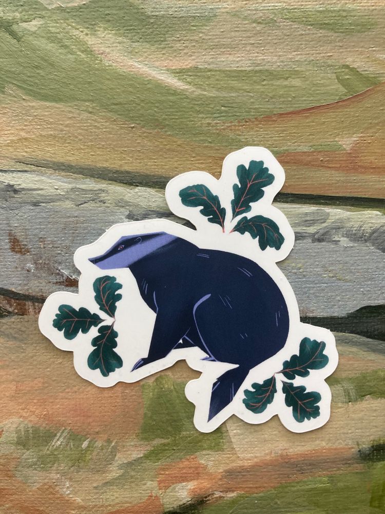 sticker of a badger surrounded by oak leaves
