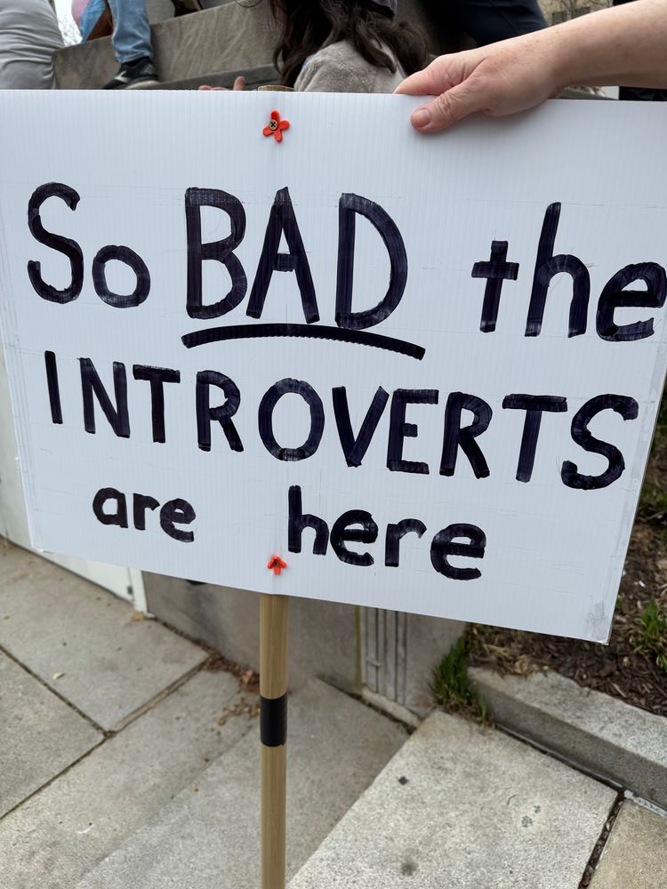 Protest sign saying “So bad the introverts are here” 