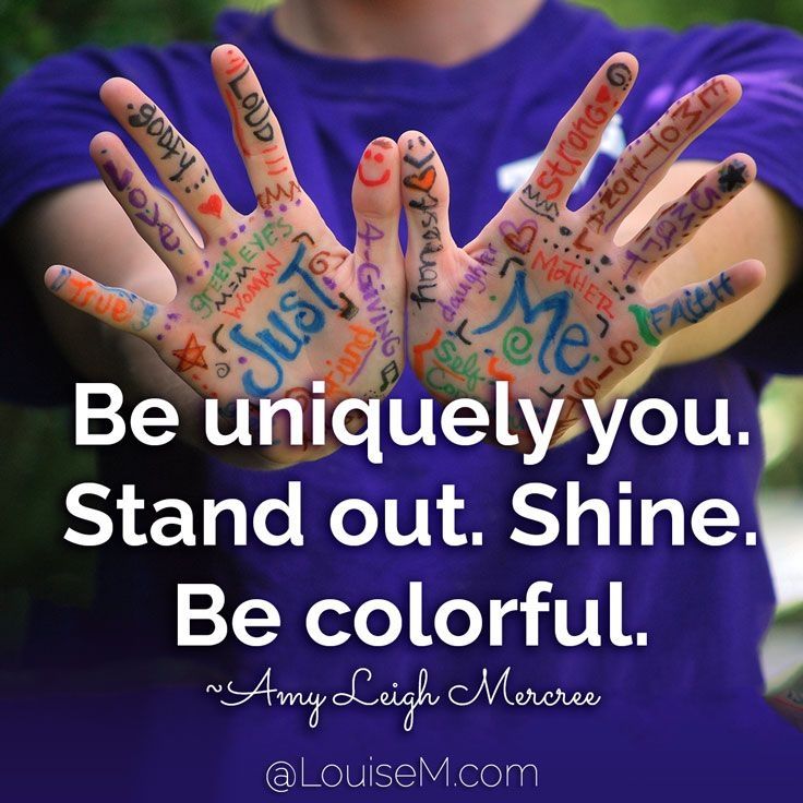 A close up of someone's hands held out, palm to the camera. Their hands are colourful with words in different colours. In the middle of each palm are the words "just" and "me" with descriptive words around them. They are wearing a dark blue/purple t-shirt. Underneath in bold white text it reads "Be uniquely you. Stand out. Shine. Be colourful." Attributed to Amy Leigh Mercree