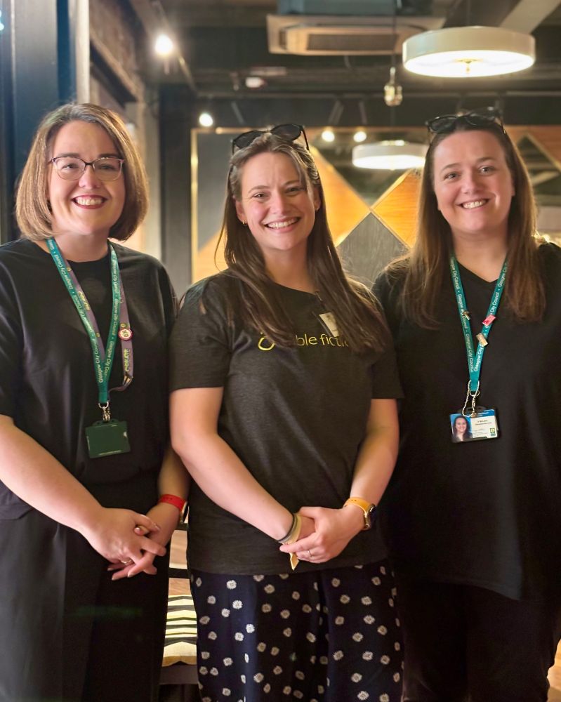 Three people wearing lanyards. 