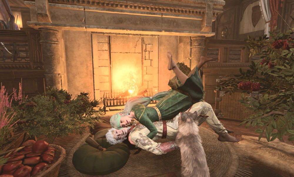 A screenshot from BG3 photo mode of my Tav Emmeryn  and Astarion and their cat. They are lying on a rug with throw pillows in front of a fireplace with holly bushes, a basket of apples and a jug of wine nearby. Emmeryn is lying on top of Astarion and kicking her legs up in the air. The are both smiling. Emmeryn is wearing a gold a green gown and Astarion is wearing a fancy red and white outfit with silver embroidery and a circlet with berries. 