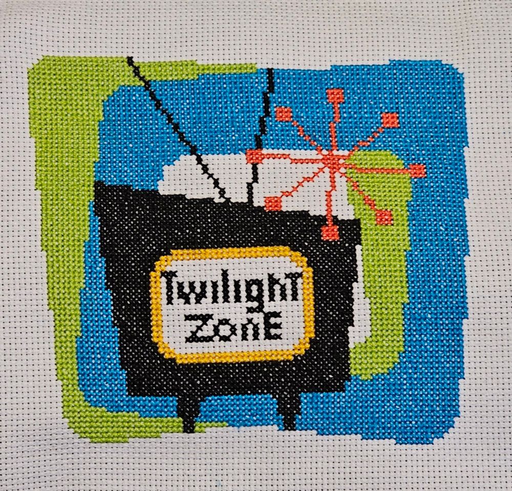 retro television with twilight zone listing, blue and green squares in the background