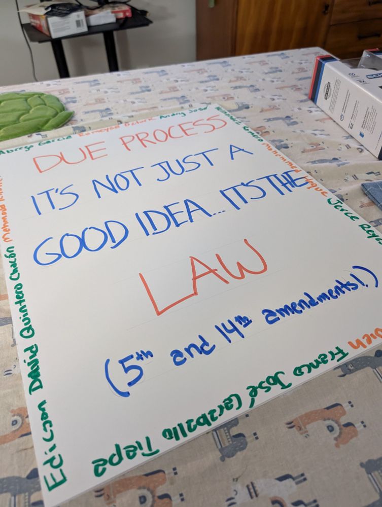 Picture of poster reading "Due process: it's not just a good idea... It's the law." With names of illegally detained people written around the sides.