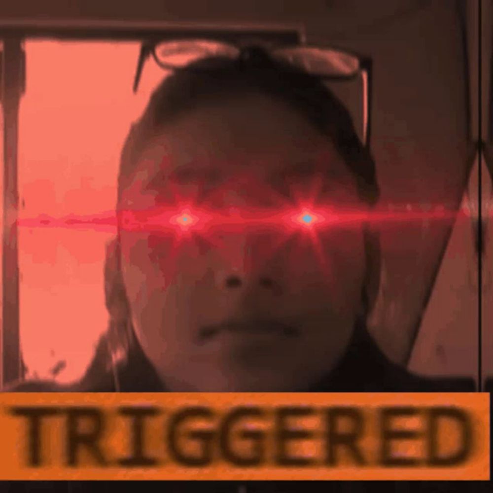 a picture of a woman with red eyes and the word triggered behind her