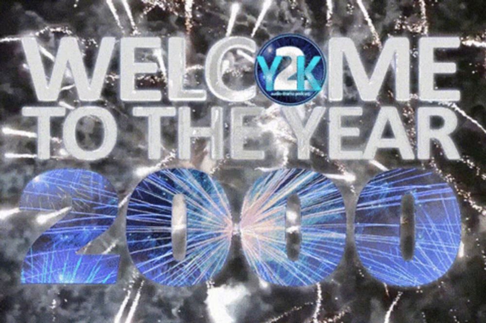 a welcome to the year 2000 sign with fireworks behind it