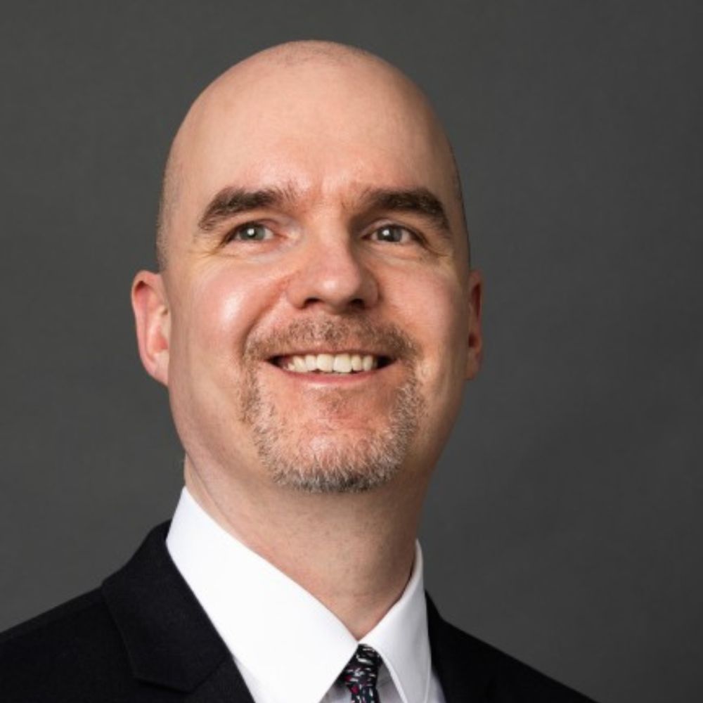 Marc Workman, CEO of the World Blind Union and co-chair of G3ict’s DASH Work Group, smiling at the camera in a professional setting. 