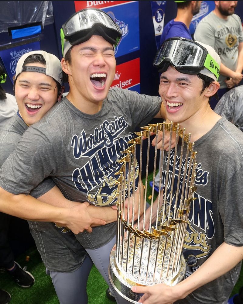 Shohei Ohtani, Yoshinobu Yamamoto, Roki Sasaki celebrate winning the World Series.