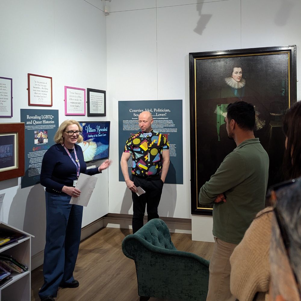 Two people, Jon Sleigh and Alison Clague, giving a presentation about the Villiers Revealed exhibition in a museum exhibition space.