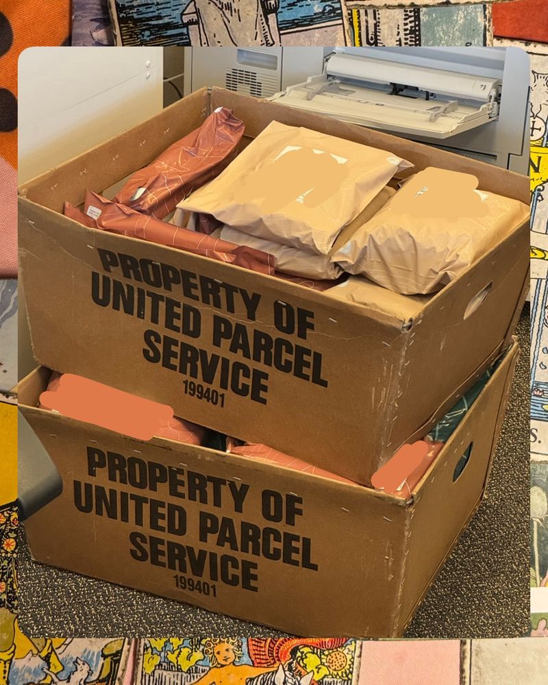 an image of two cardboard boxes labeled ‘Property of United Parcel Service’ full of individual packages from Hushfall Archives that have been handed off to ship. the photo is layered over a background image of vintage tarot cards.