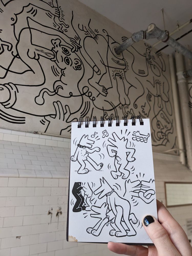 A sketchbook with Keith Haring-inspired drawings of frisky dogmen, photographed in the Haring Bathroom at the LGBT Community Center, New York City.