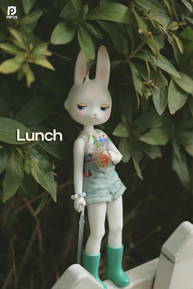 White Rabbit doll, with extremely cunty side eye. She's got a drink and an umbrella, and is wearing wellies and a plaid shirt and shorts